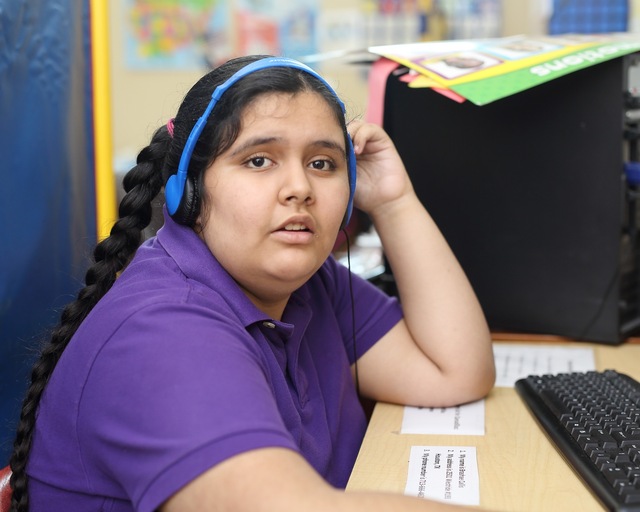 Brittany does her classwork with headphones