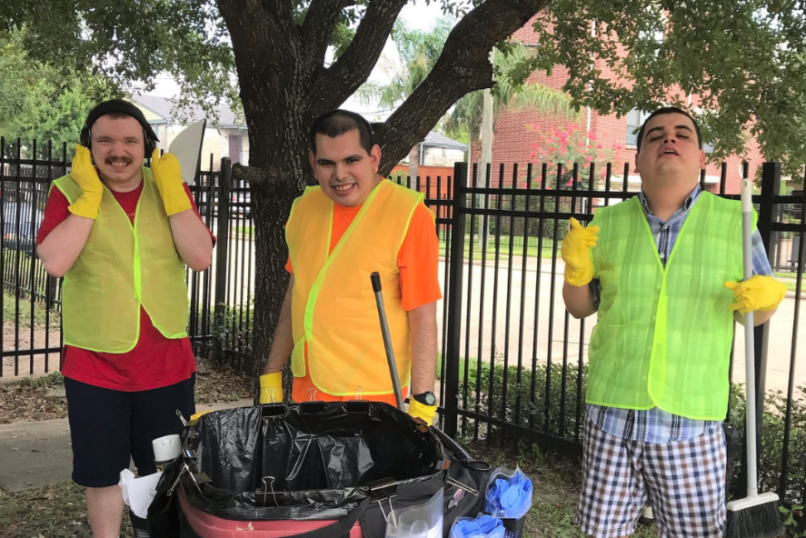 Two men smiling with yellow vests on